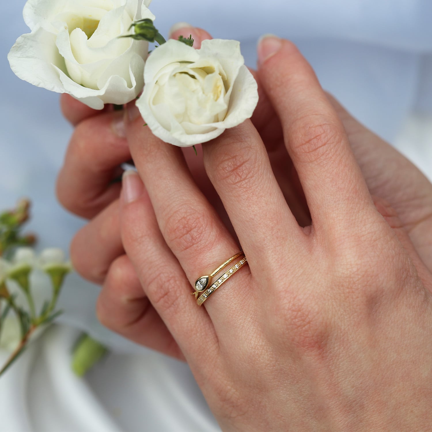 Model shot of Tulip Leaf Diamond Band and Spring Halo Diamond Eternity Ring by Alex Monroe Jewellery