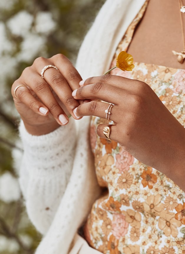 Model wearing a gold plated Honey Bee Signet Ring stacked by Alex Monroe Jewellery