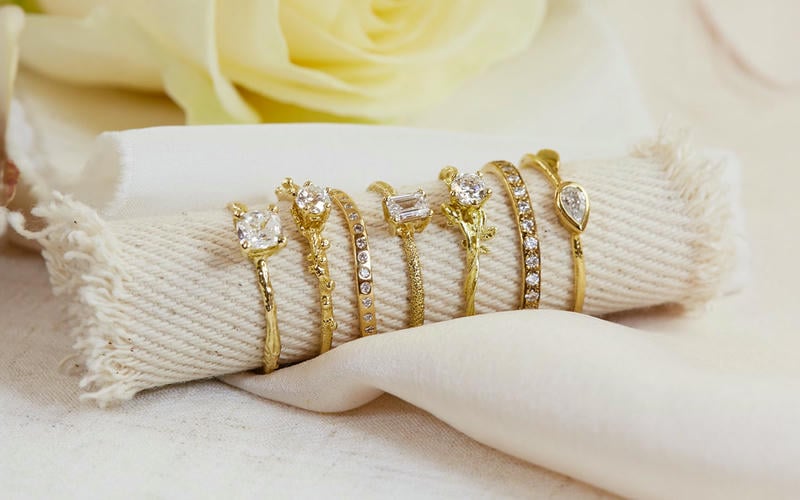 Selection of solid gold solitaire diamond rings and diamond set eternity bands with different size and shape diamonds, including brilliant cut, teardrop and emerald cut.