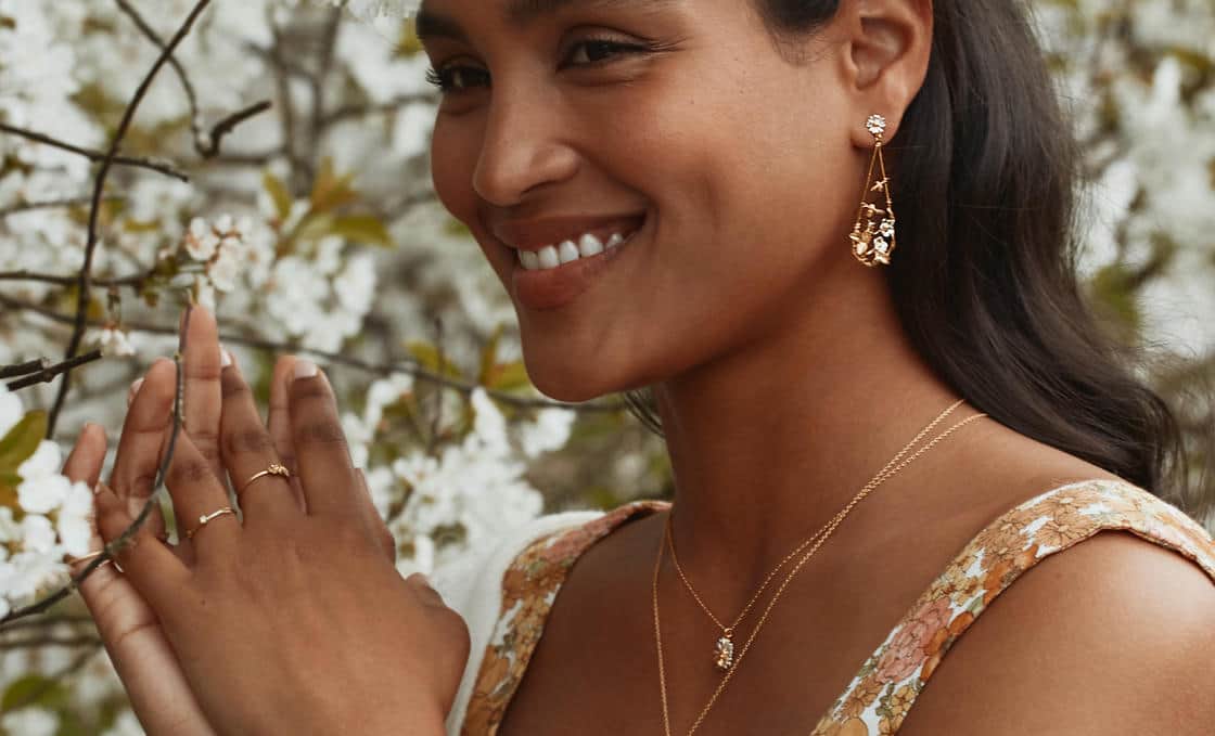 White plastic ring sizer on a green background.