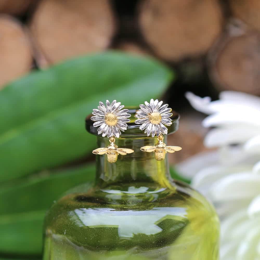 Silver turtle necklace resting on textured blue fabric