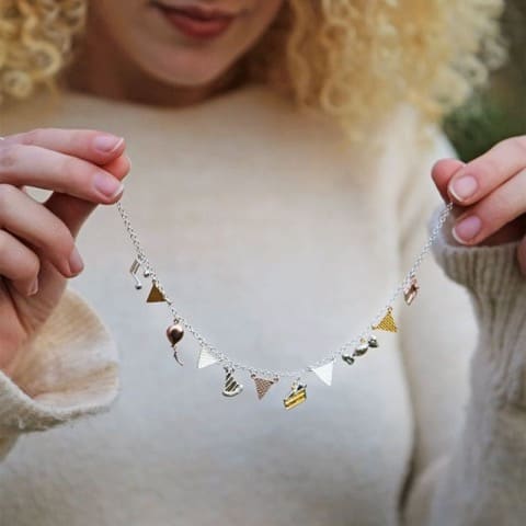 model holding the Alex Monroe Party Necklace mixed metal sterling silver, gold plate and rose gold plate