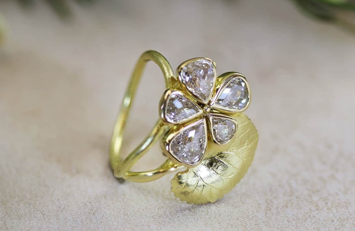 Large Violet flower cocktail ring with five diamonds set in a flower shape.