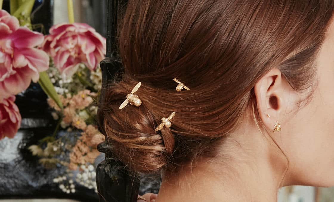 White plastic ring sizer on a green background.