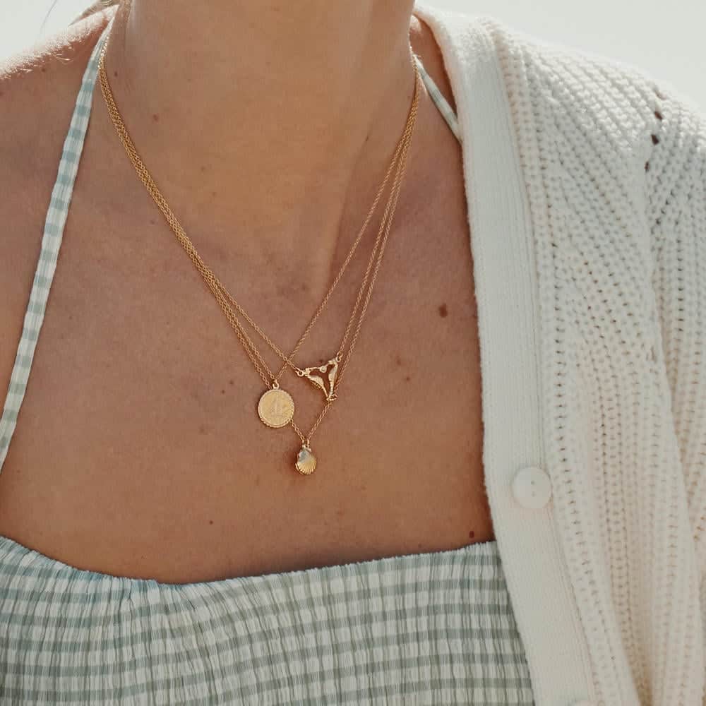Model wearing silver Tumbling Wildflower Pearl Drop Earrings