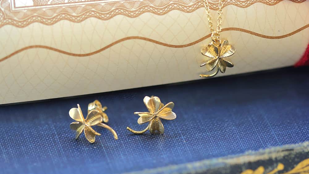 Gold four leaf lucky clover stud earrings and necklace.