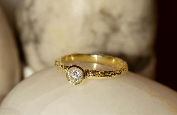 Close up of a bark textured diamond ring.