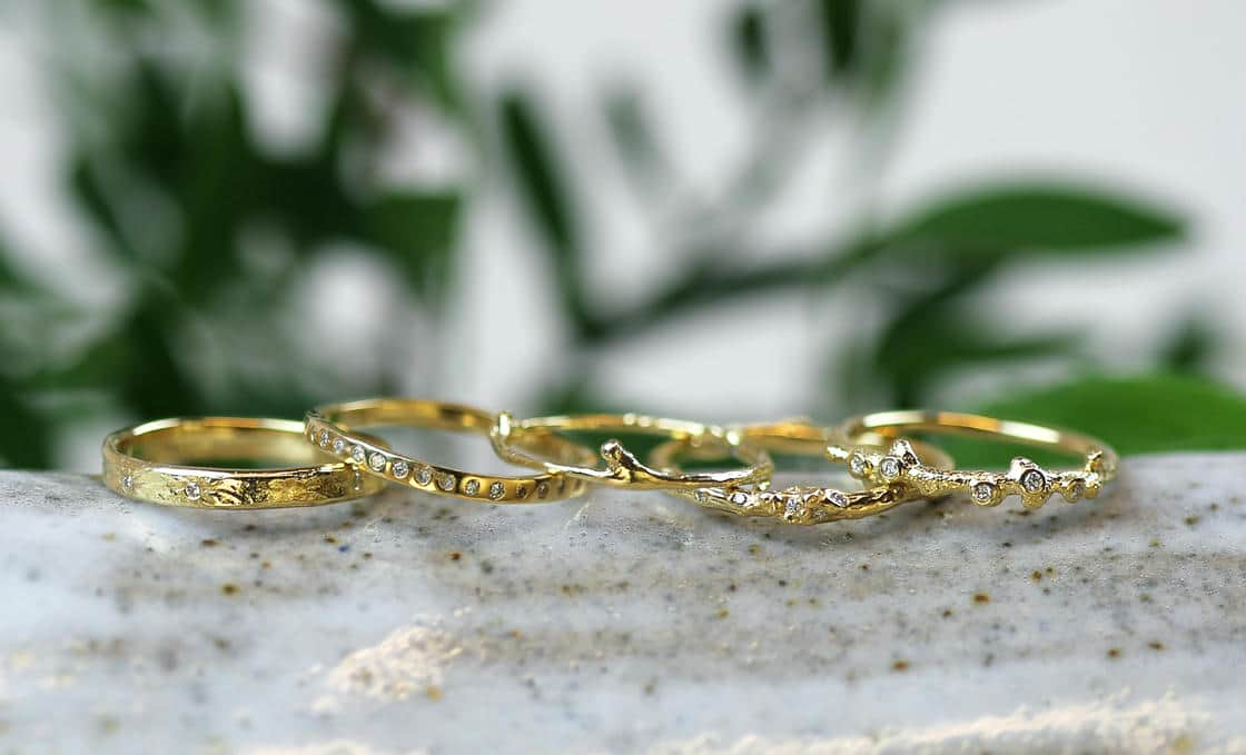 White plastic ring sizer on a green background.