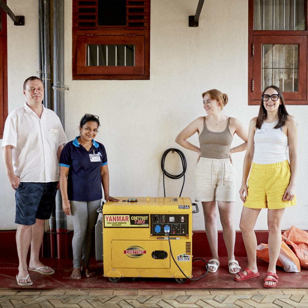 Members of the Sunrise Facets and Alex Monroe teams stood next to a new generator.