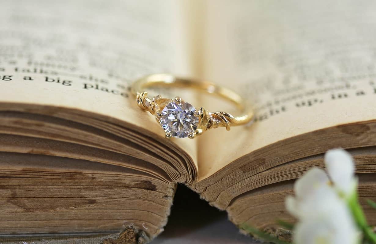 Three pale blue Amethyst gemstones scattered on a white surface.