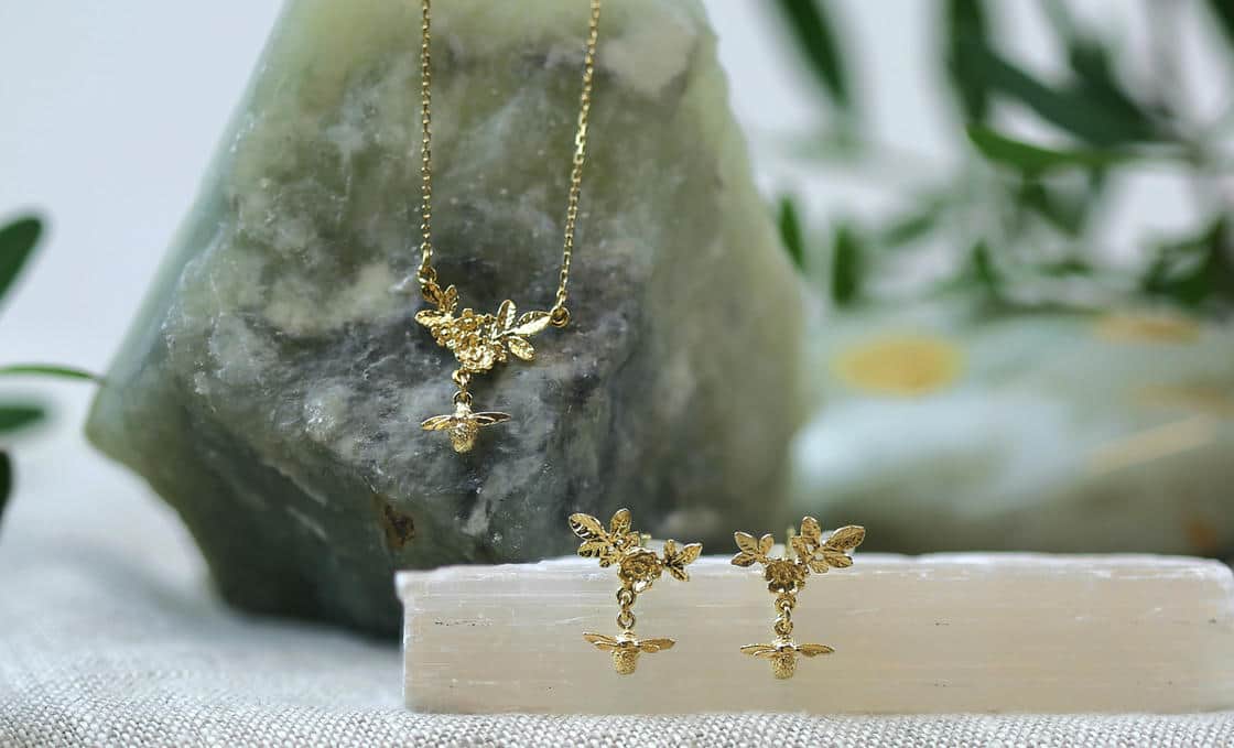 White plastic ring sizer on a green background.