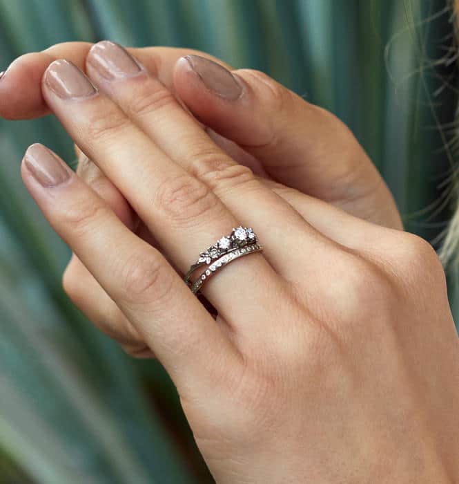 Large diamond vine leaf yellow gold ring on a piece of paper with pencil design sketches of the ring.