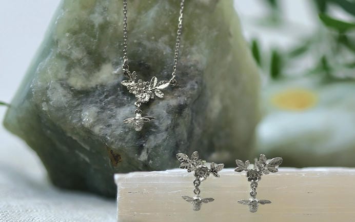 Solid 18ct white gold bee and leaf motif necklace and earrings.