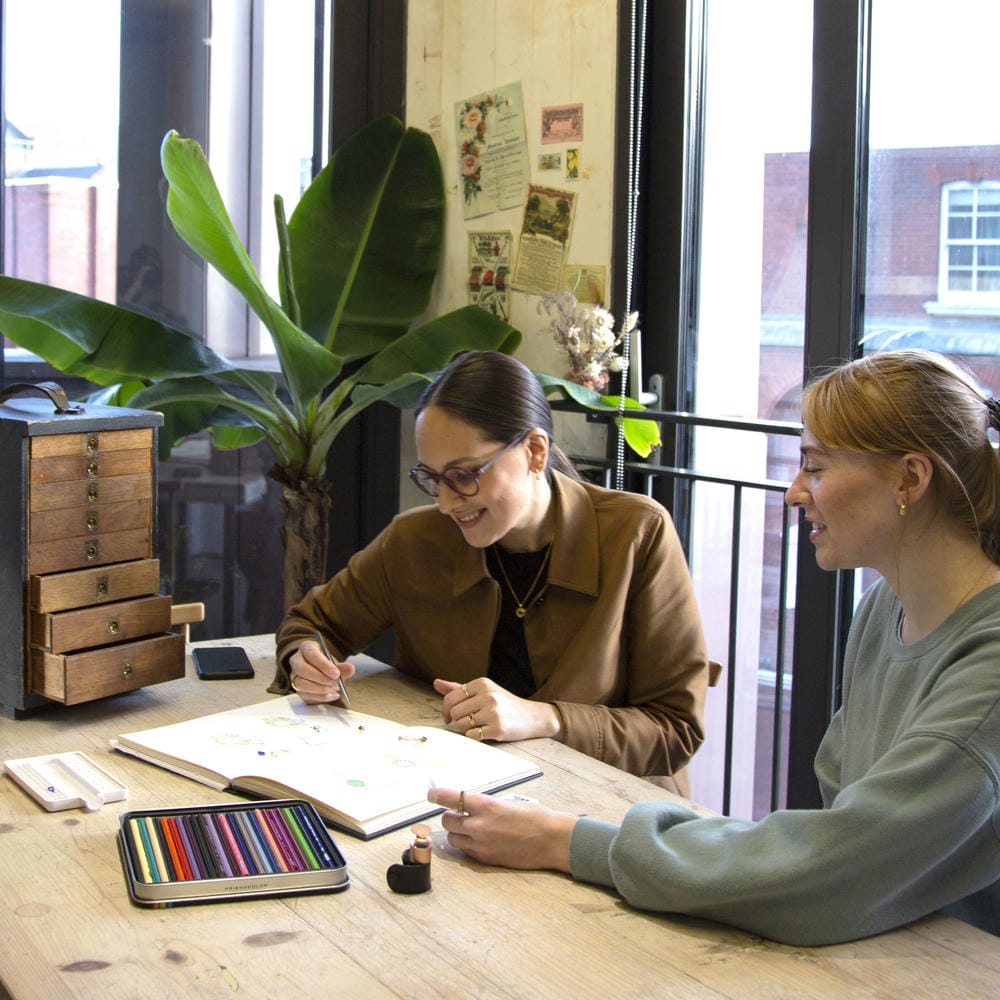 Two of the Alex Monroe Design team sketching in the design studio.